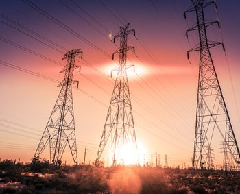 Electricity supply towers as sun sets