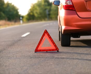 Red triangle of a car on the road