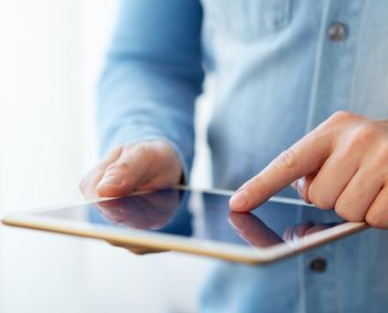 Man touching digital tablet, view close up