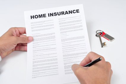 closeup of a young man signing a home insurance policy