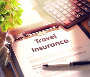 Business Concept - Travel Insurance on Clipboard. Composition with Office Supplies on Desk. Travel Insurance- Text on Clipboard with Office Supplies on Desk. 3d Rendering. Toned and Blurred Image.